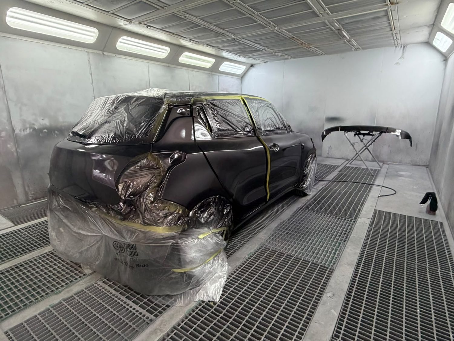 A car masked up in the spray booth for paint repair at Mobile Dent Pro